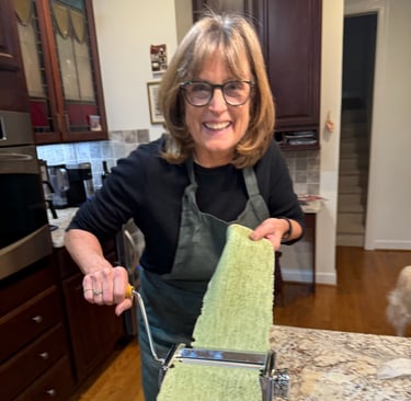 Class participant hand rolling spinach pasta noodle