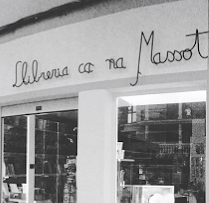 a store front of a store with a woman in a dress