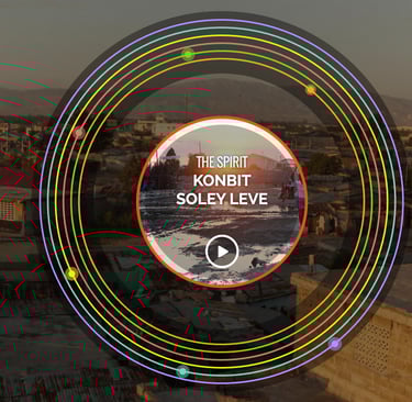 Website with colored circles; text: “The Spirit: Konbit Anba Soley” before Haiti’s Sunset of Soleil.