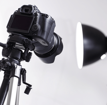 a camera and a light on a tripod