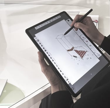 a person holding a pen and drawing on a tablet a conceptual architectural drawings