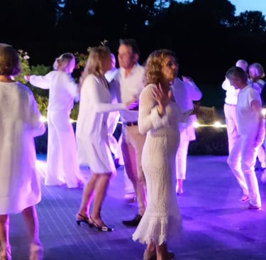a group of people standing around a table with drinks