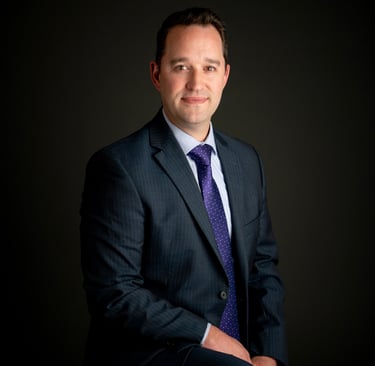 a man in a suit and tie posing for a portrait