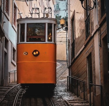 a trolley car on a narrow street in a Lisbon