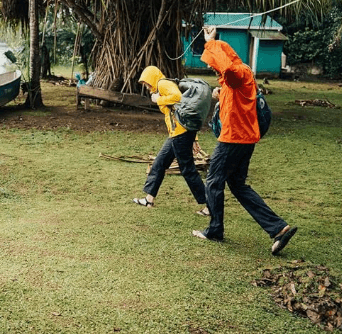 a man and a woman are flying a kite