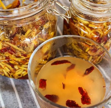 Glass of tea with jujube and honey, jars of fruit behind