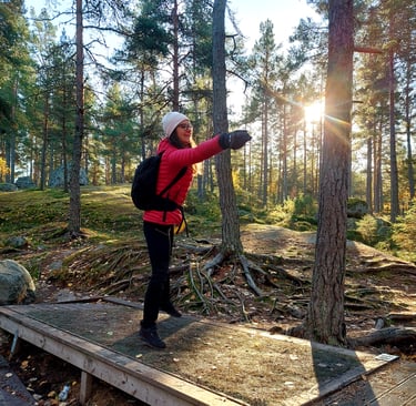a woman in a red jacket throwing a frisbee
