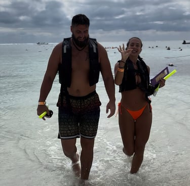 a man and woman walking in the water