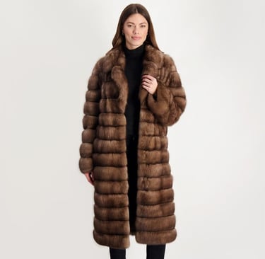 a woman in a long brown gorski coat with a fur coat