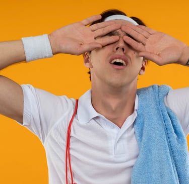 a man with a towel around his shoulder. He's tired an sweaty