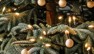 a christmas tree with gold ornaments and a christmas tree