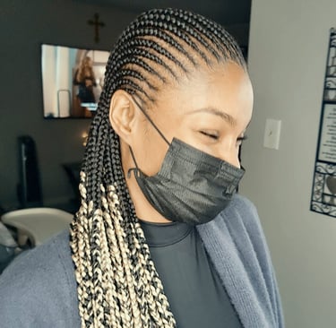 a woman with cornrows hairstyle