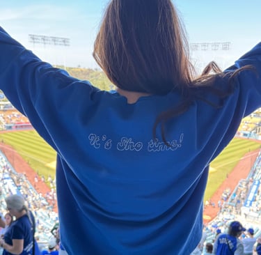 back of a sweatshirt on a girl at a baseball stadium