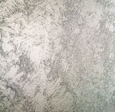 A cool silver paint sample showing off its shimmering grainy texture.