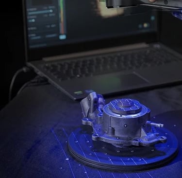 car part being 3d scanned with a blue laser