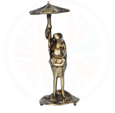 brass frog under a umbrella