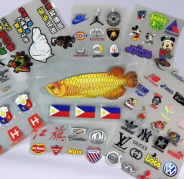 Assorted collection of UV DTF printed brand stickers on a transparent sheet.