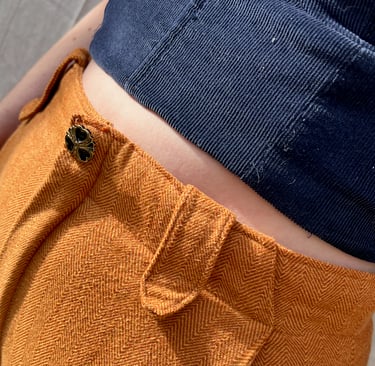 Waist detail of a navy corduroy bustier and honey brown flannel pants