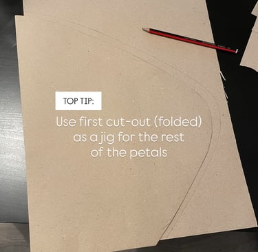 brown paper petal folded in half to use as a jig or mould