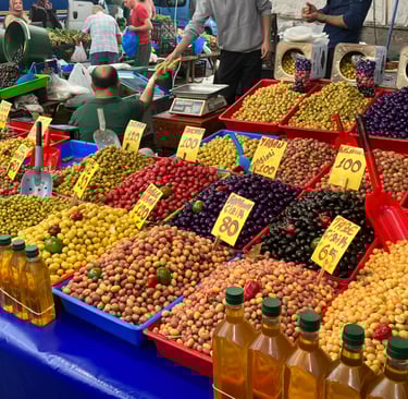 a table with olives and olive oil bottles