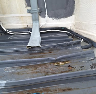 Overflowing roof gutter with poor drainage