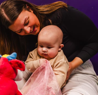 Mum looking over and smiling at her baby in Moo Music Worksop.