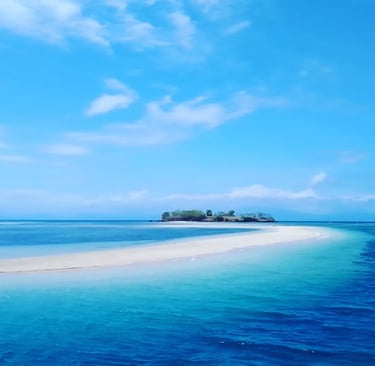 a small island with a small island in the middle of the ocean of Pink Beach