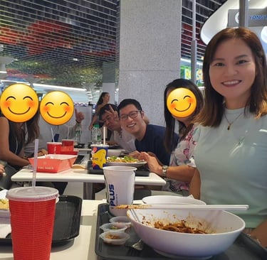 a group of people sitting at a table with smiley faces