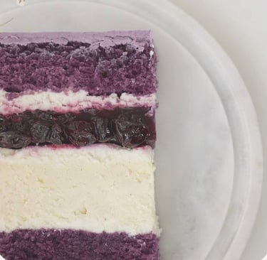 a piece of cake with a purple and white background