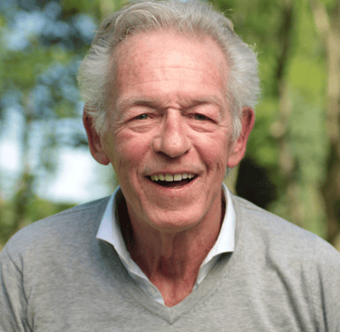an older man with a smile on his face