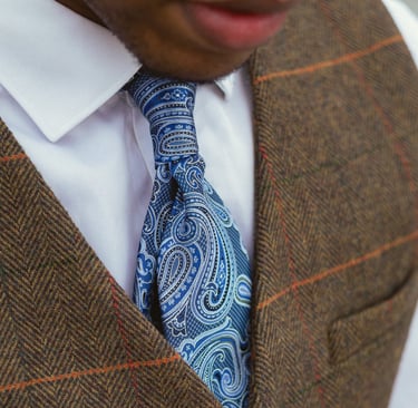 "Personal stylist sitting showing men tie"