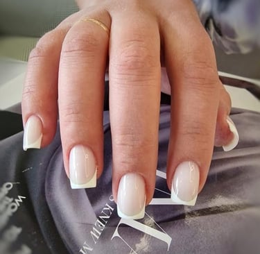 a person's hand with a computer mouse on a mouse pad