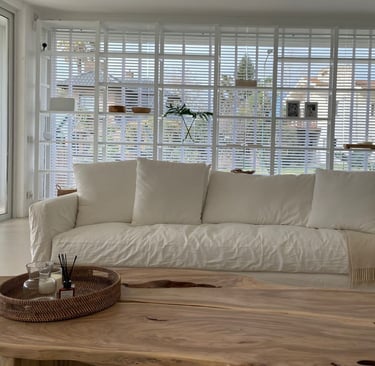 a living room with a couch and a wooden table