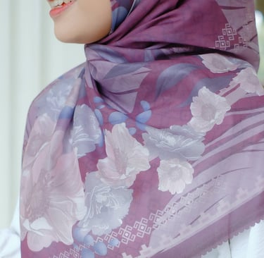 a woman wearing a purple scarf and a white dress