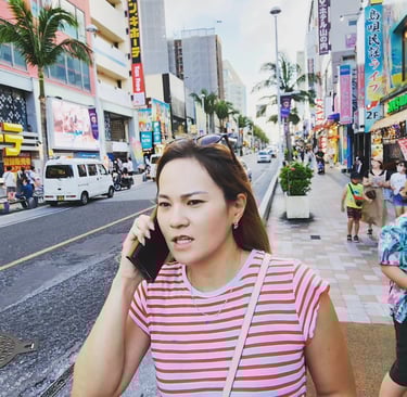 a japanese woman talking on her cell phone