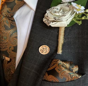 a man in a suit and tie with a flower made from music paper