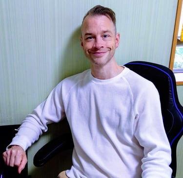an online English teacher sitting at a computer desk