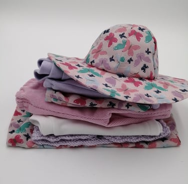 A pile of dolls clothes