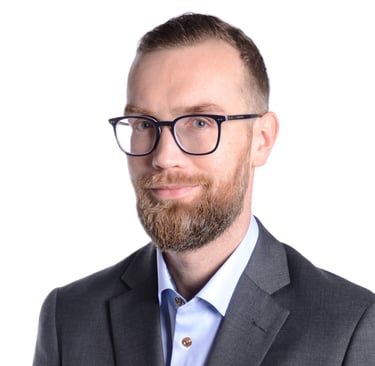 a man in a suit and glasses posing for a picture