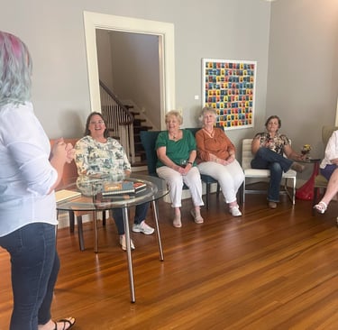 Tabitha with butterfly effect consulting talking to a group of clients at Main Street House