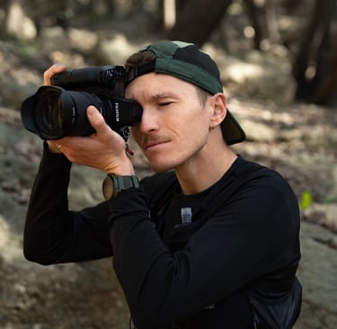 a man taking a picture of himself in the woods