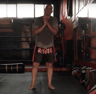 A man in a boxing ring with a punching bag!