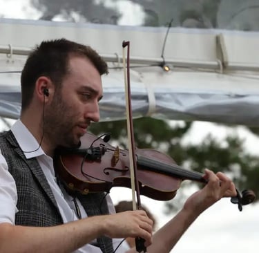 Professional fiddle player performing traditional Irish folk music for a Devon ceilidh band at a wedding