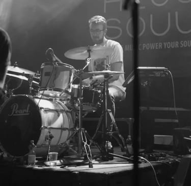 Close-up of Mosaic's drummer performing a high-energy rhythm set at a wedding reception