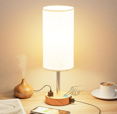 Fenmzee Bedside Table Lamp on a wooden nightstand with soft light.