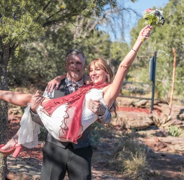 a man and woman are holding a flower