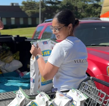 Volunteer smiling while at communtiy food delivery event