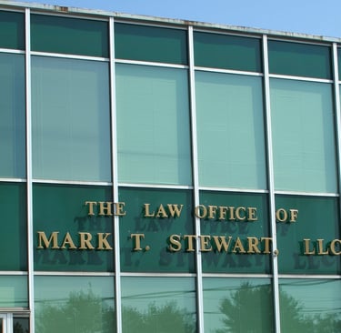 a building with a sign that says the law office of Mark T. Stewart