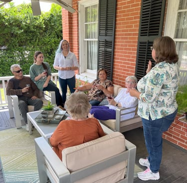 a group of people sitting on a porch