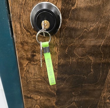 Wooden door with a key in the keyhole representing Jack’s Locksmith local rekeying services in Spruce Pine, NC